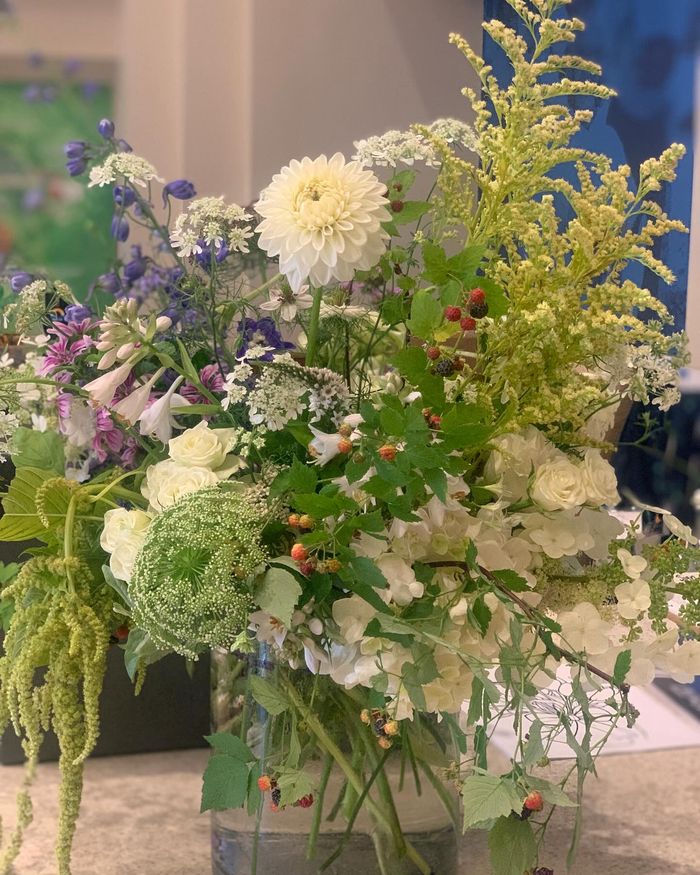 A tall arrangement of golden rod, rust and green textures